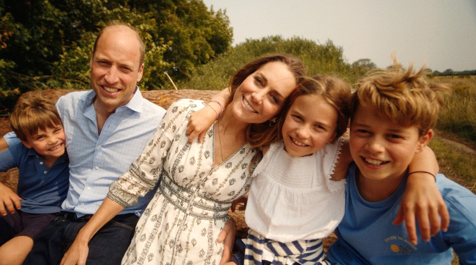 a family posing for a picture with a boy wearing a shirt that says ' sydney ' on it