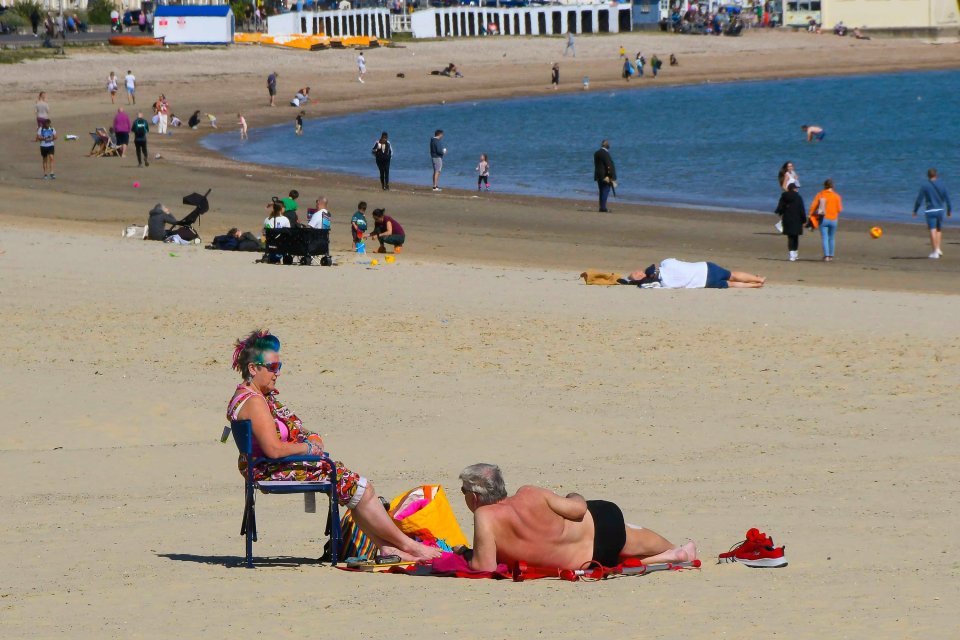 Sunbathers lapped up the warm weather today like here in Weymouth, Dorset