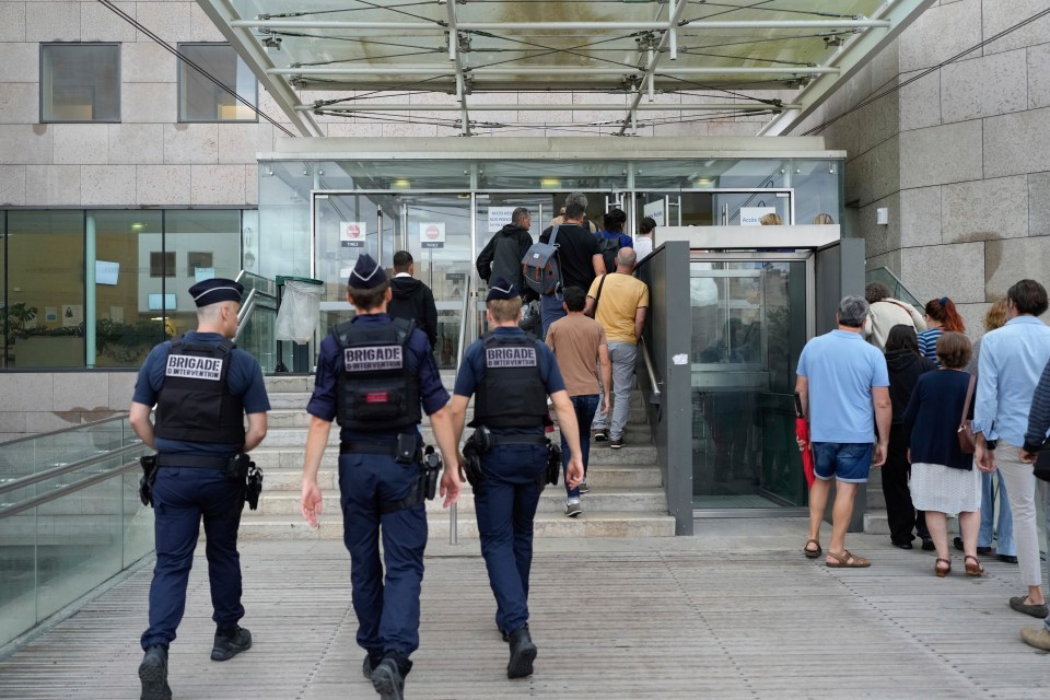 a group of police officers are walking down a set of stairs