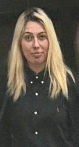 a woman with blonde hair is wearing a black shirt .