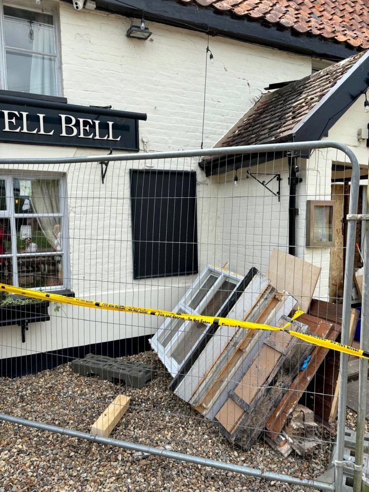 a fence in front of a building that says ' ell bell ' on it