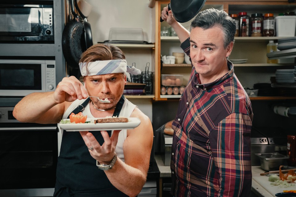 a man with a bandana on his head is holding a plate of food