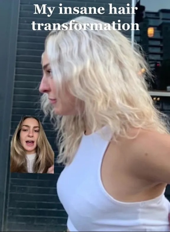 a woman with blonde hair is standing in front of a deli sign