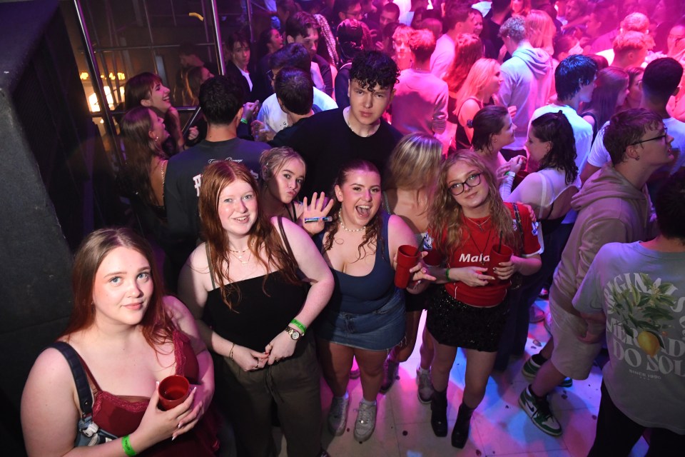 a girl in a red shirt with the word mala on it