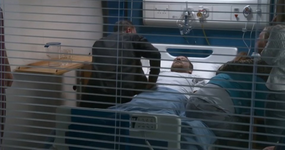 a man laying in a hospital bed with coronation street itv written on the bottom