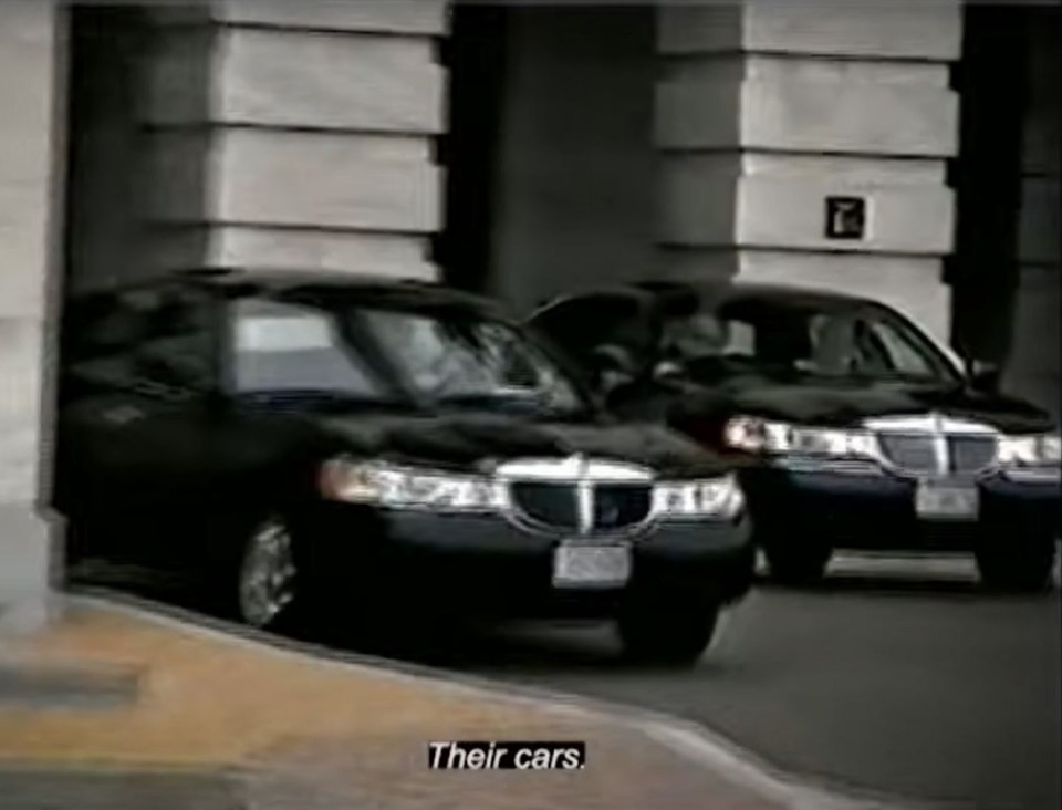 He films a set of limousines in front of the Capitol