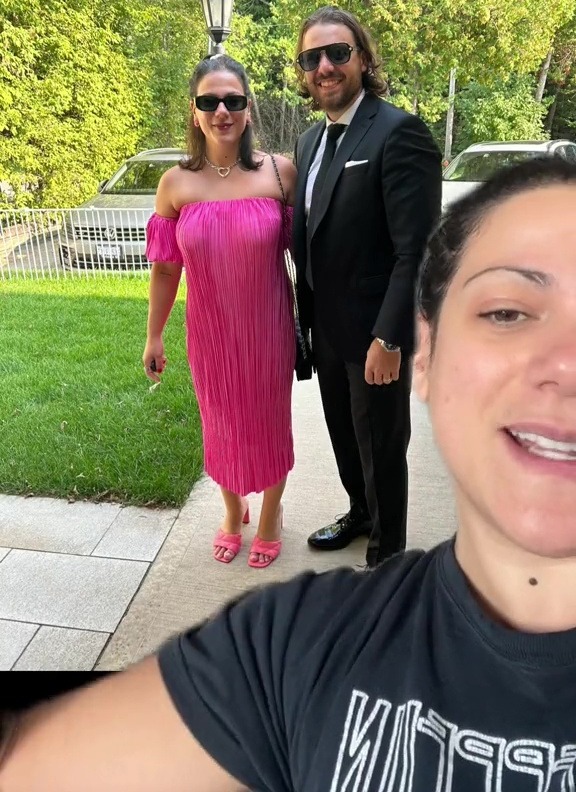 a man in a tuxedo stands next to a woman in a pink dress