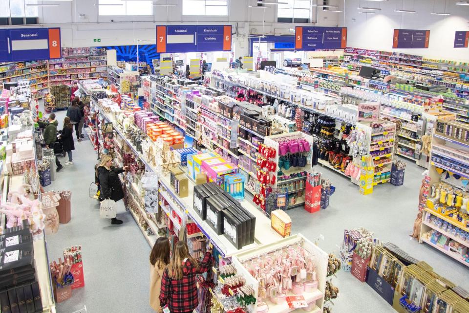 an aisle in a store with a sign that says seasonal