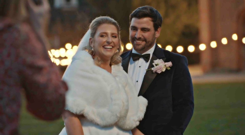 a man is taking a picture of a bride and groom