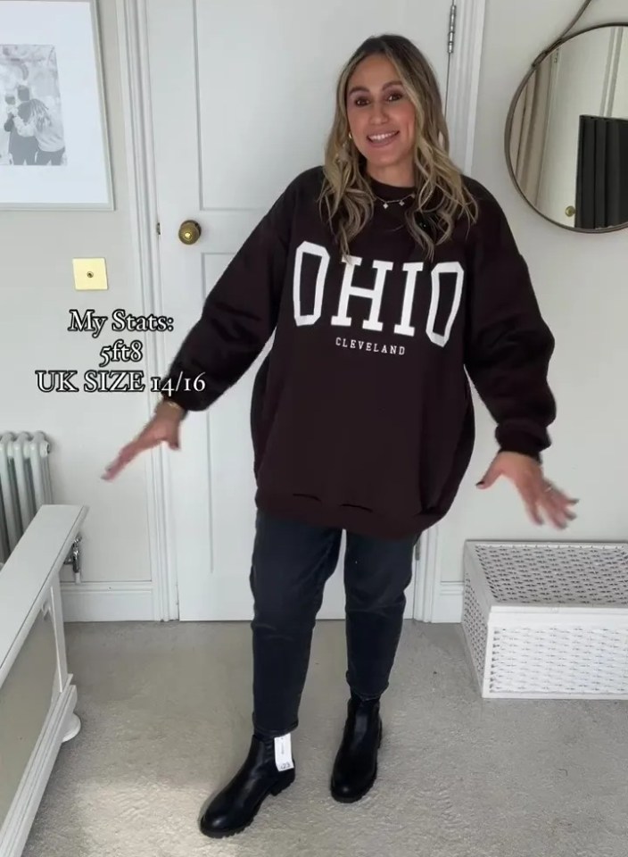 a woman is wearing a brown ohio sweatshirt