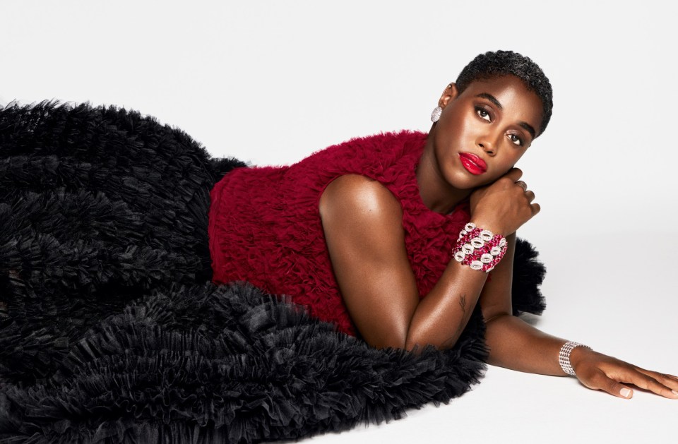 a woman in a red top and black skirt is laying on the floor