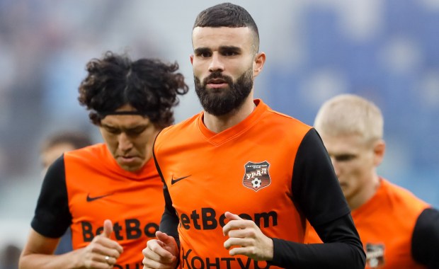 a group of soccer players wearing orange jerseys that say betboom