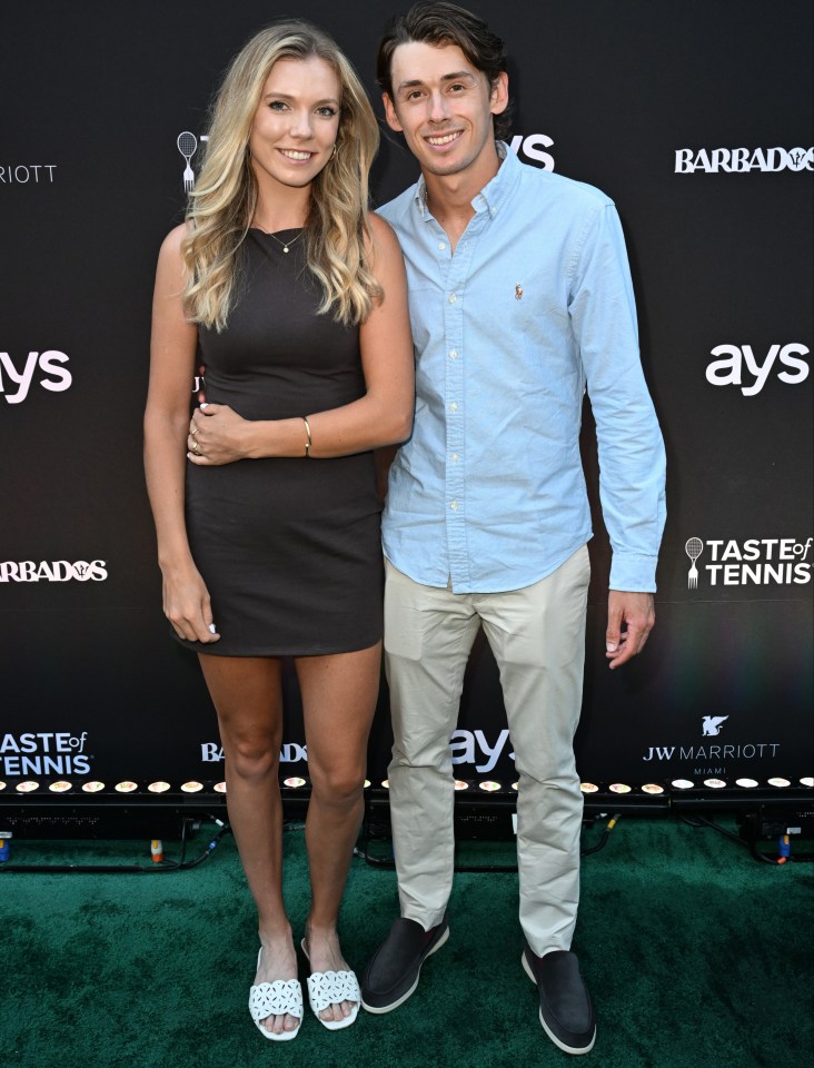 a man and a woman pose for a photo in front of a wall that says taste of tennis