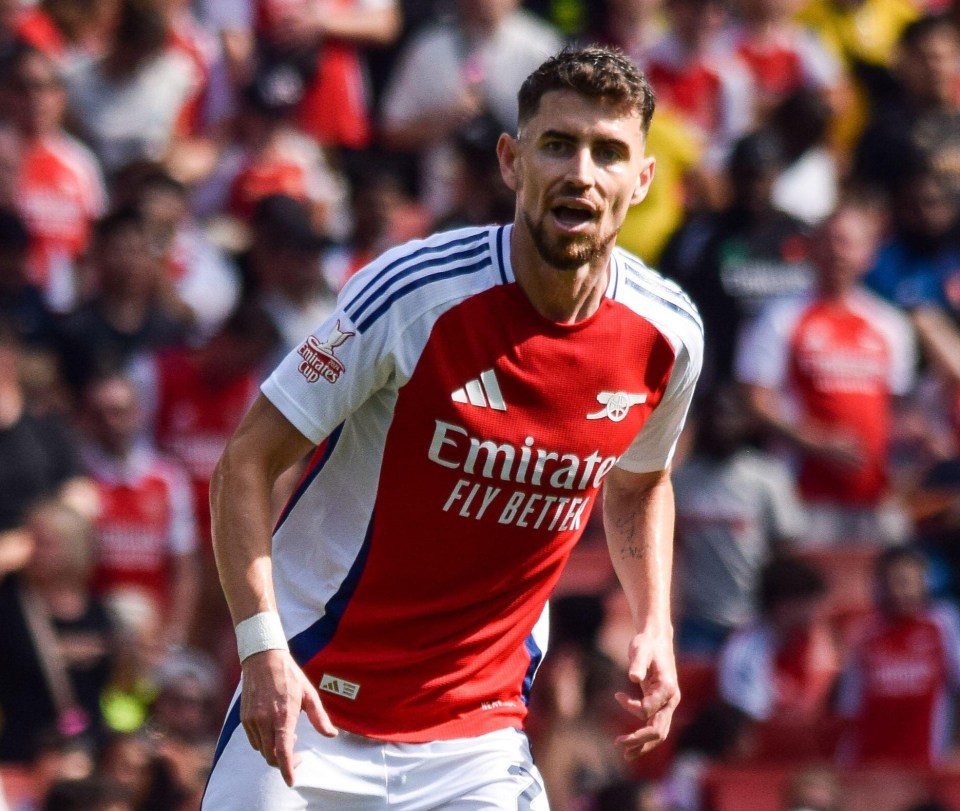 a soccer player wearing an emirates fly better jersey