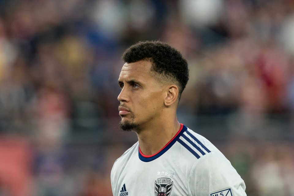 a soccer player wearing a white adidas jersey