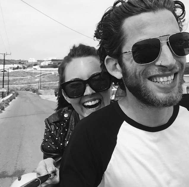 a man and a woman wearing sunglasses are smiling