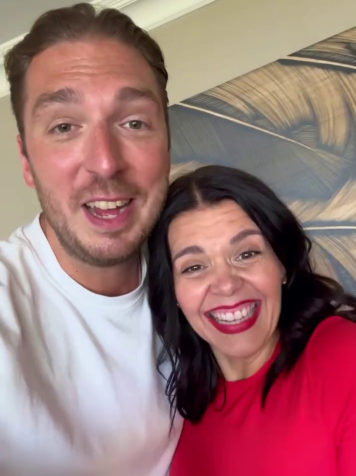 a man and a woman are posing for a picture and the woman is wearing red lipstick