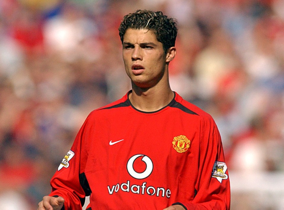 a soccer player wearing a red vodafone jersey