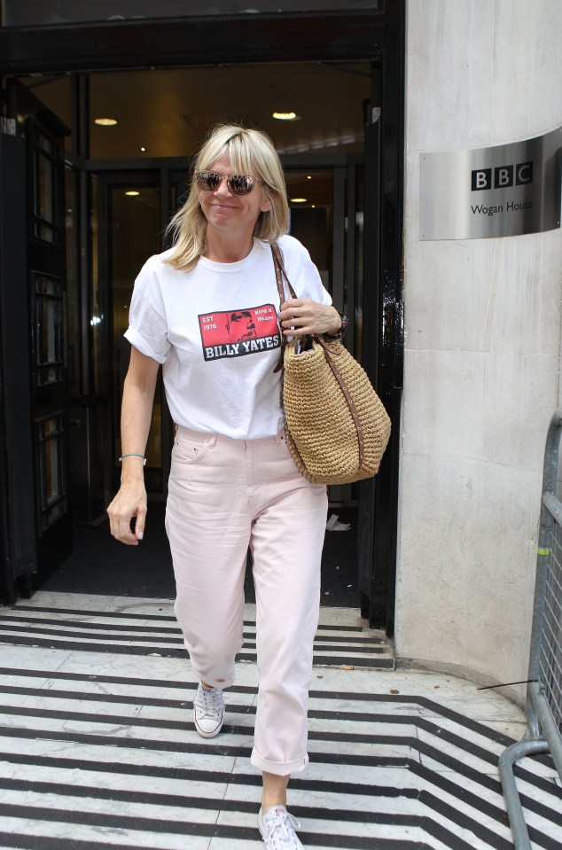 a woman wearing a white shirt that says billy tate