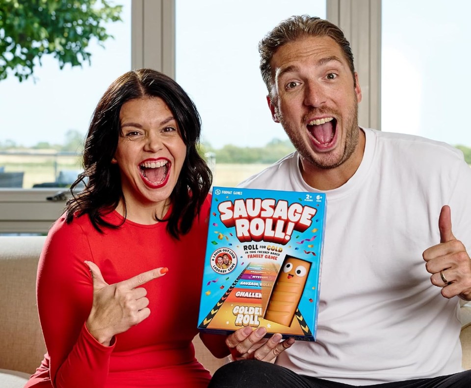 a man and a woman are holding a box of sausage rolls