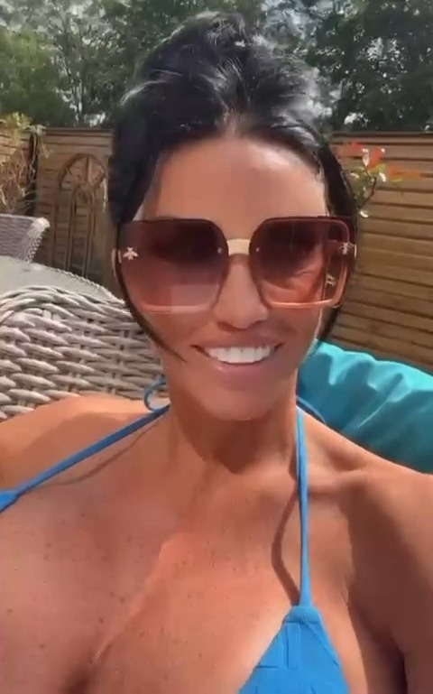 a woman in a blue bikini and sunglasses is smiling .