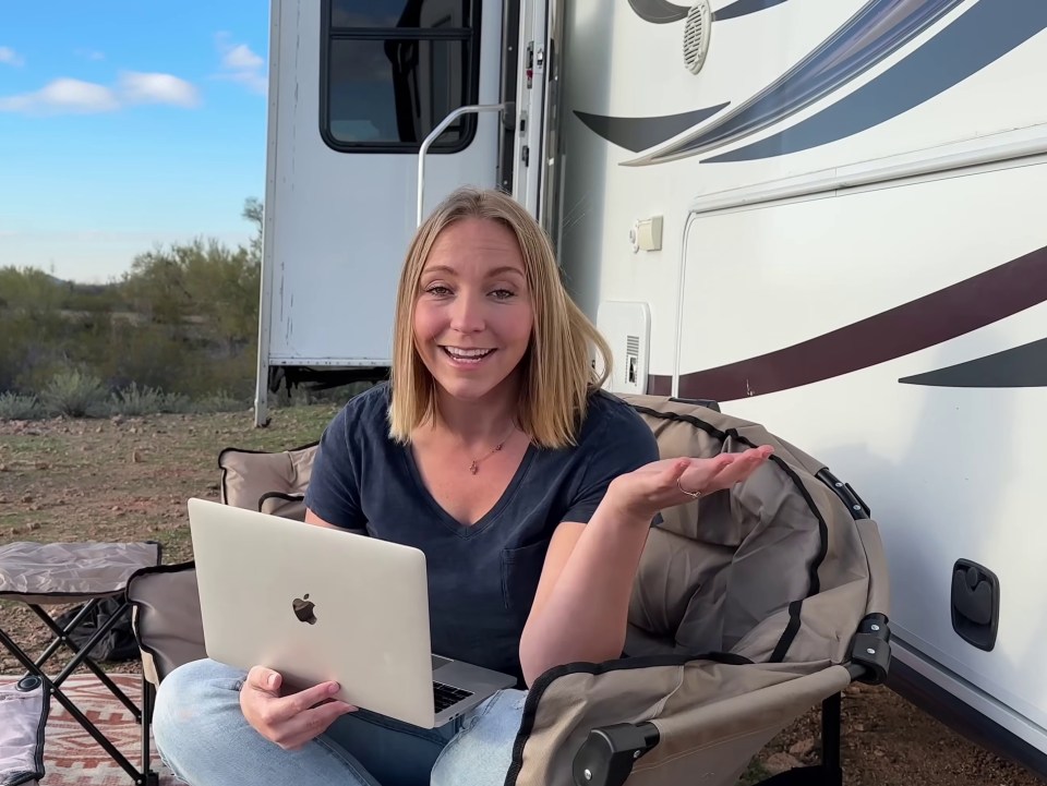 a woman sits in a chair with an apple laptop and a monthly average of $ 2,011