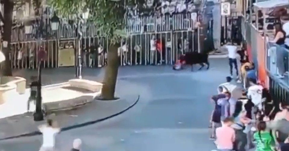 a group of people walking down a street with a sign that says no parking