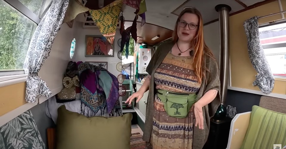 a woman in a colorful dress is standing in a room