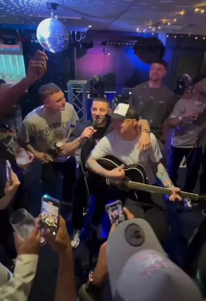 a group of men are playing guitars and singing into microphones at a party .