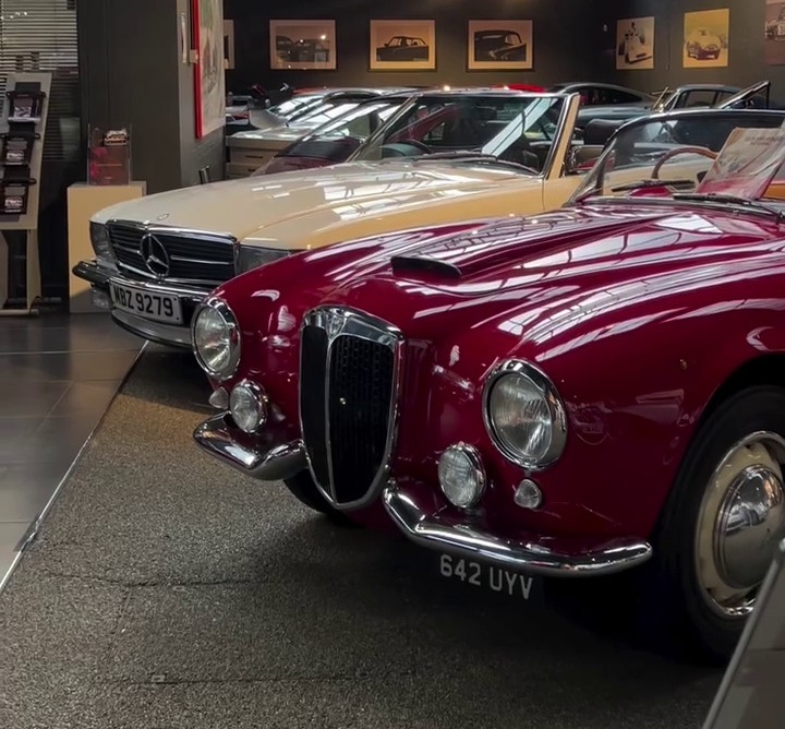 a row of vintage cars in a garage with the words delicious pizza & classic vintage cars