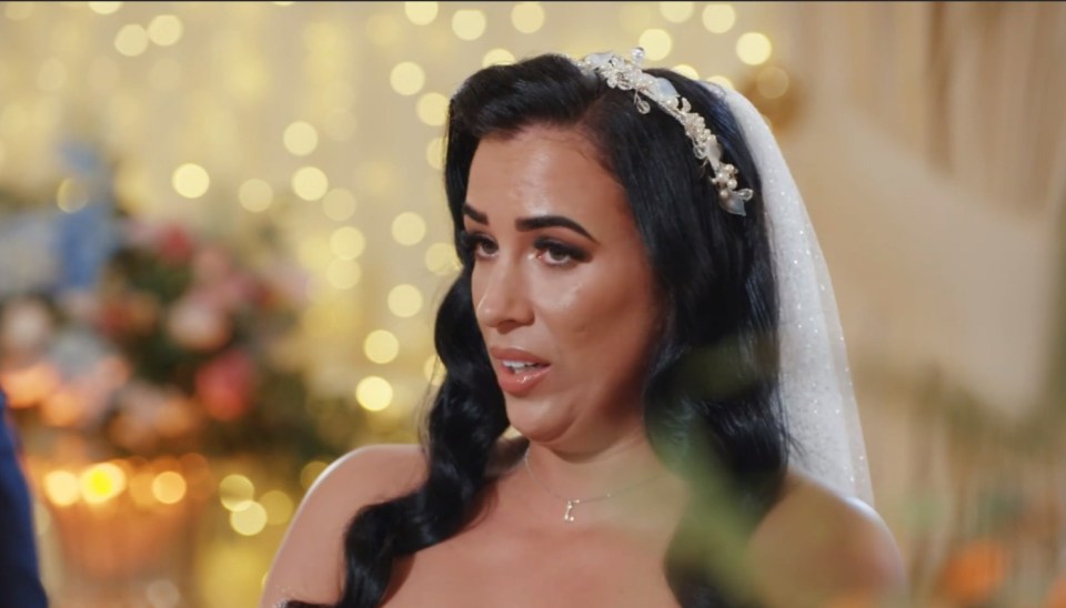 a woman in a wedding dress with a veil on her head