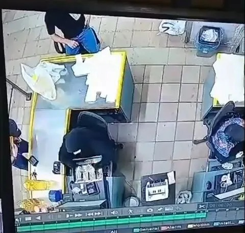 CCTV filmed inside the shop shows a man on the left checking what looks like a pager in his left pocket