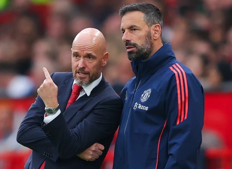 two men on a soccer field with one wearing a jacket that says adidas