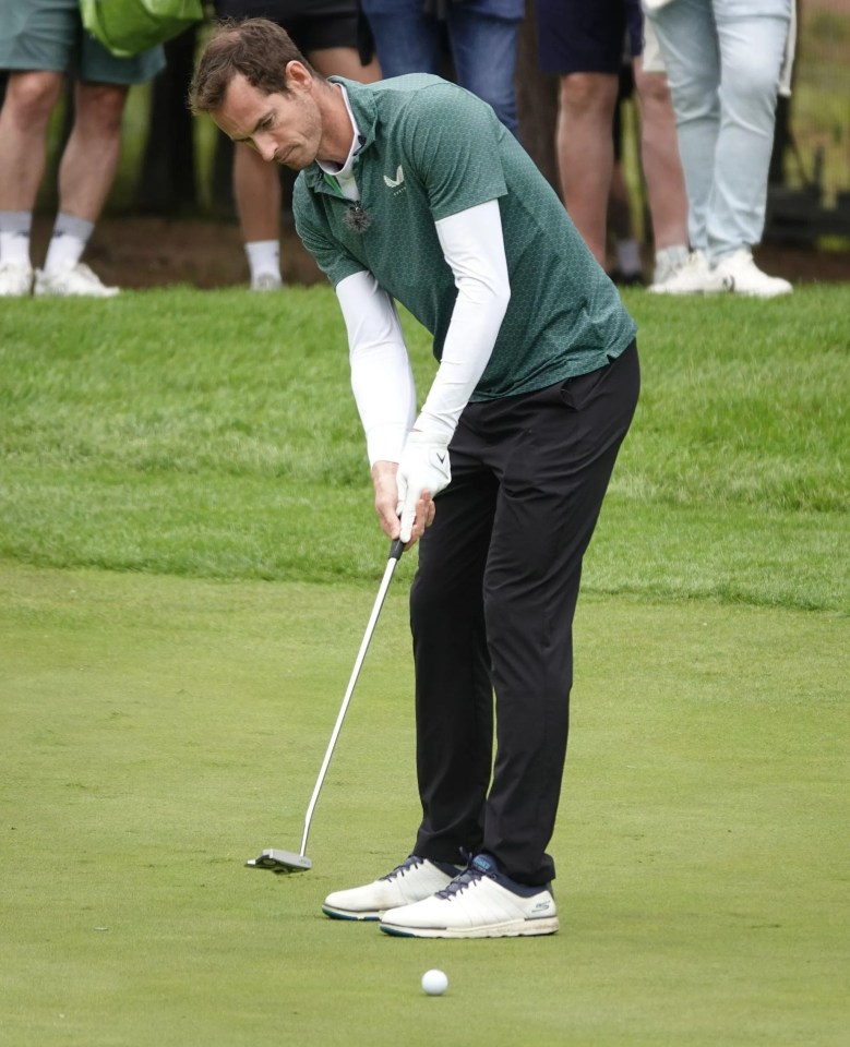 a man in a green shirt is putting a golf ball