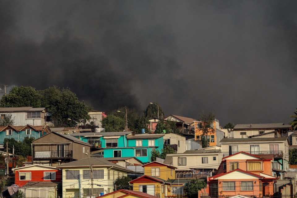 Smoke rises as the fire draws to close to homes