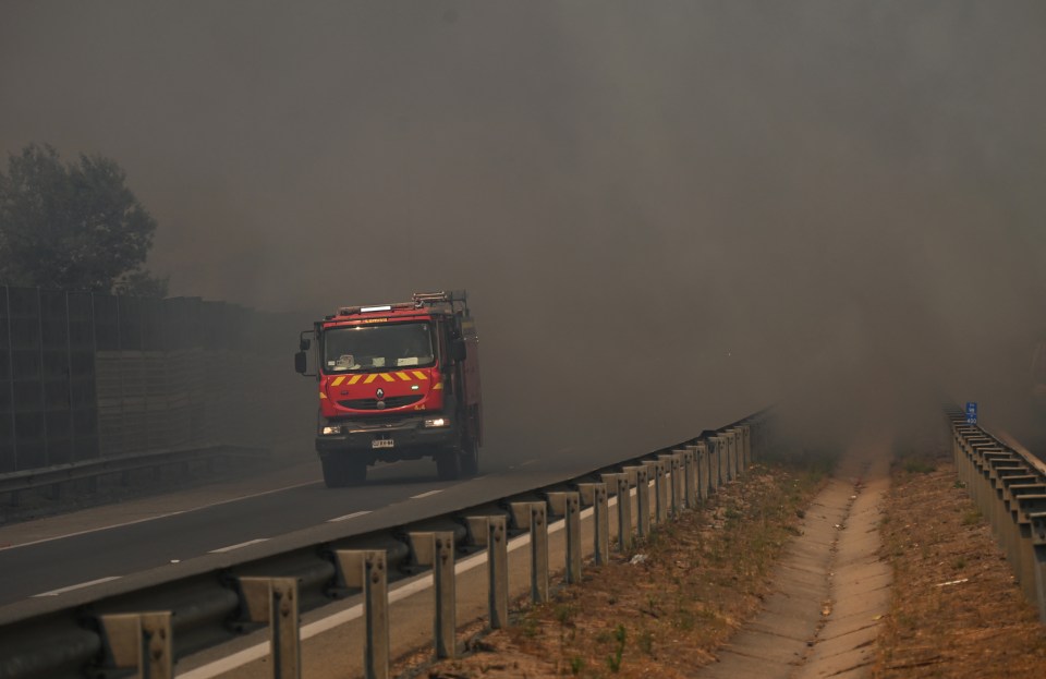 A fire truck rushes to contain the blaze