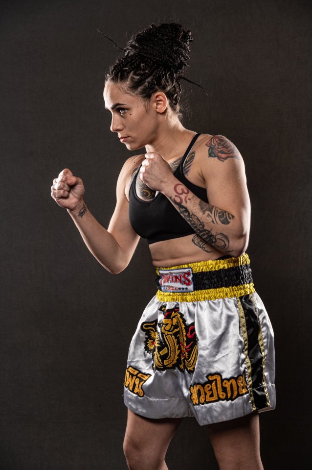 a woman wearing boxing shorts that say ' wins ' on them