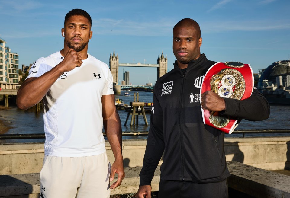 two men standing next to each other with one wearing a jacket that says kcs sports