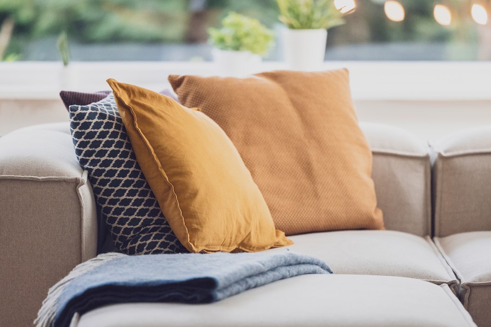 a couch with pillows and a blanket on it