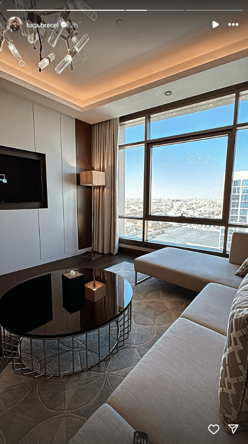 a living room with a round coffee table and a flat screen tv