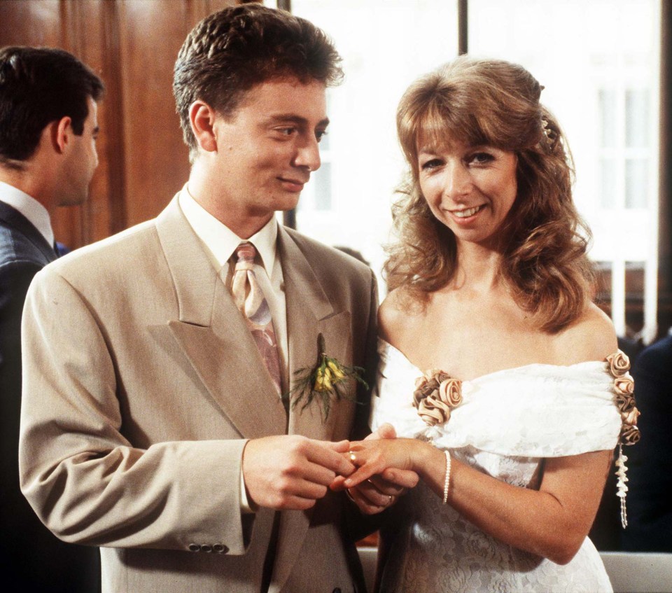 a man putting a wedding ring on a woman 's finger