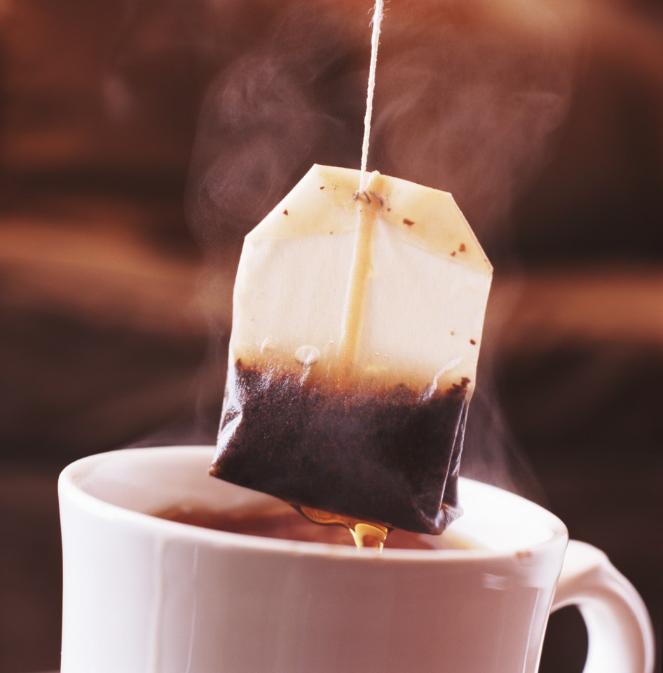 a tea bag is being poured into a cup of tea