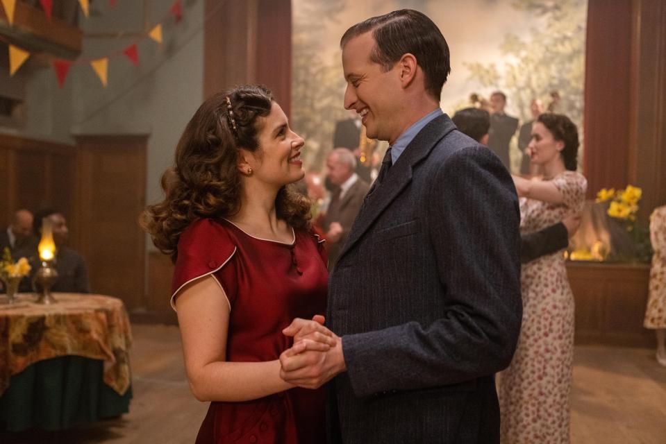 a man and a woman are dancing together in a room