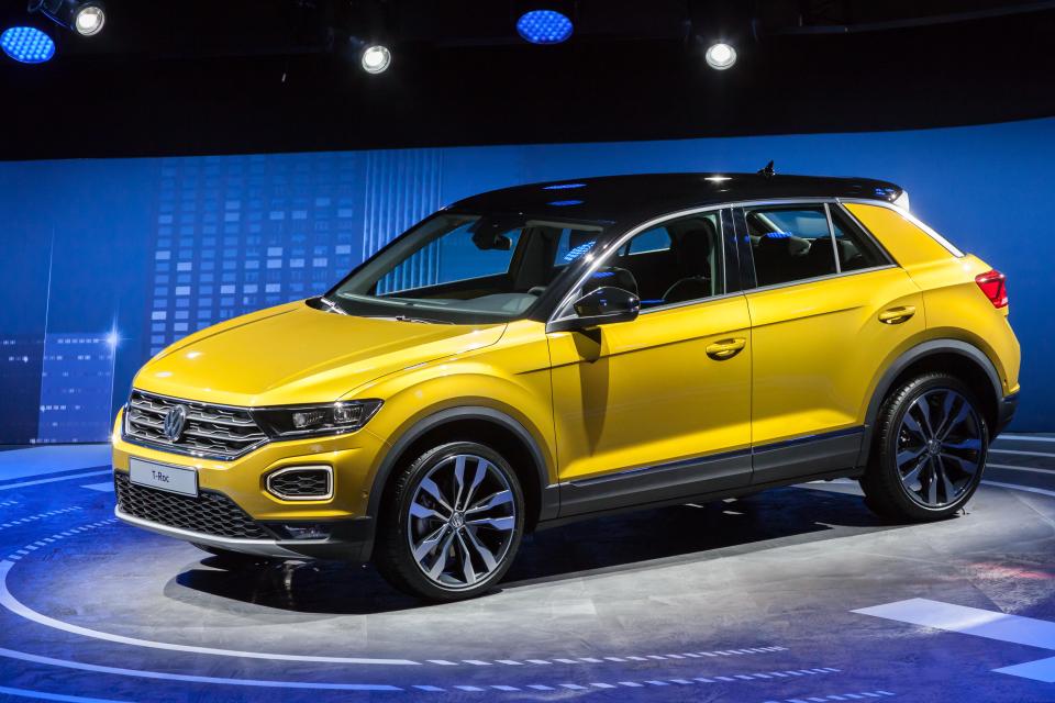 a yellow volkswagen t-roc is on display at a car show