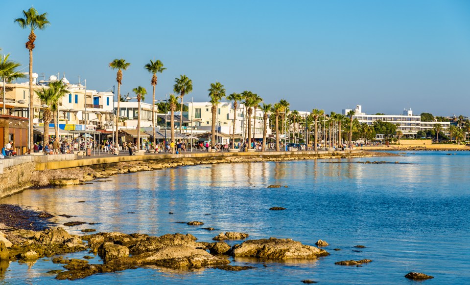 a row of buildings along the shore of a body of water