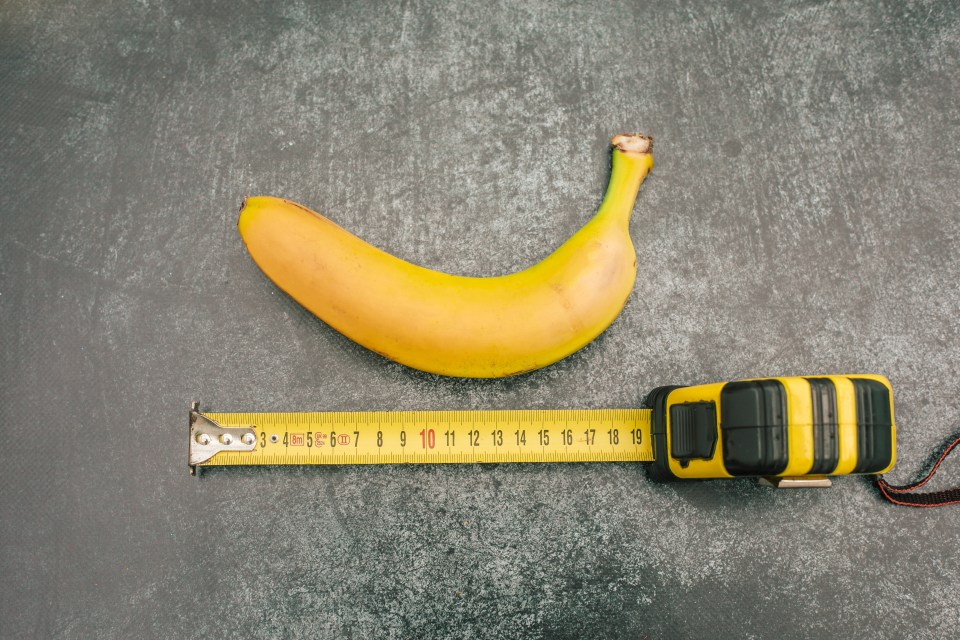 a banana is next to a tape measure that goes up to 19