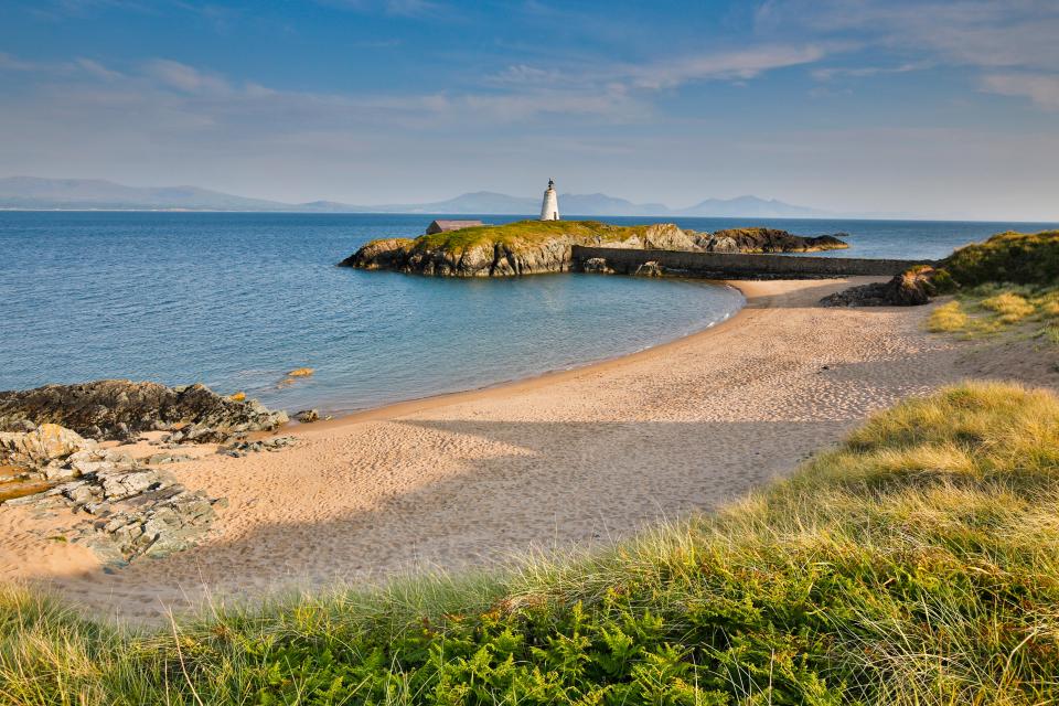 Traeth Llanddwyn (Llanddwyn Beach) is backed by Newborough National Nature Reserve and Forest