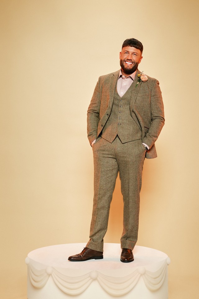 a man in a suit is standing on top of a cake