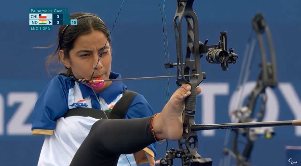 a woman is playing archery at the paralympic games