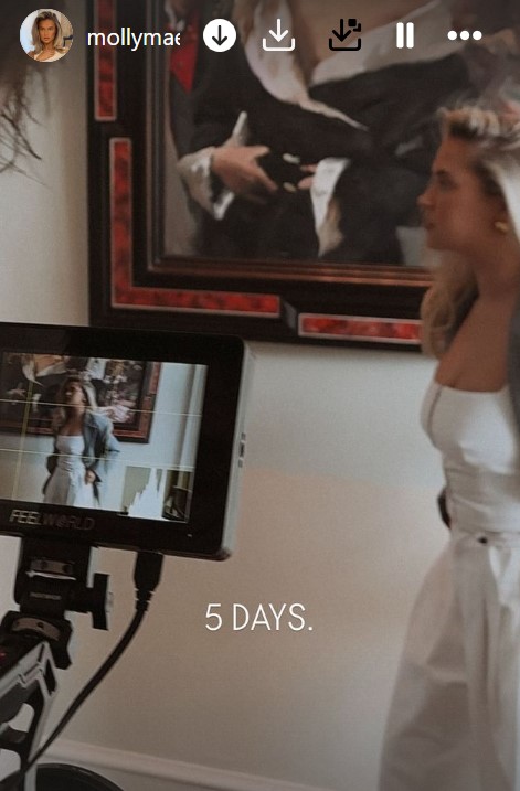 a woman in a white dress is standing in front of a screen that says 5 days